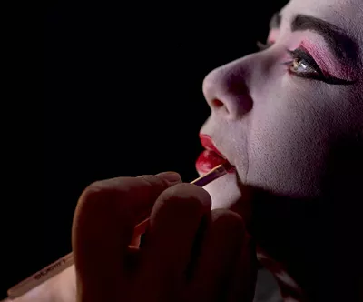 A woman gets her lips made up